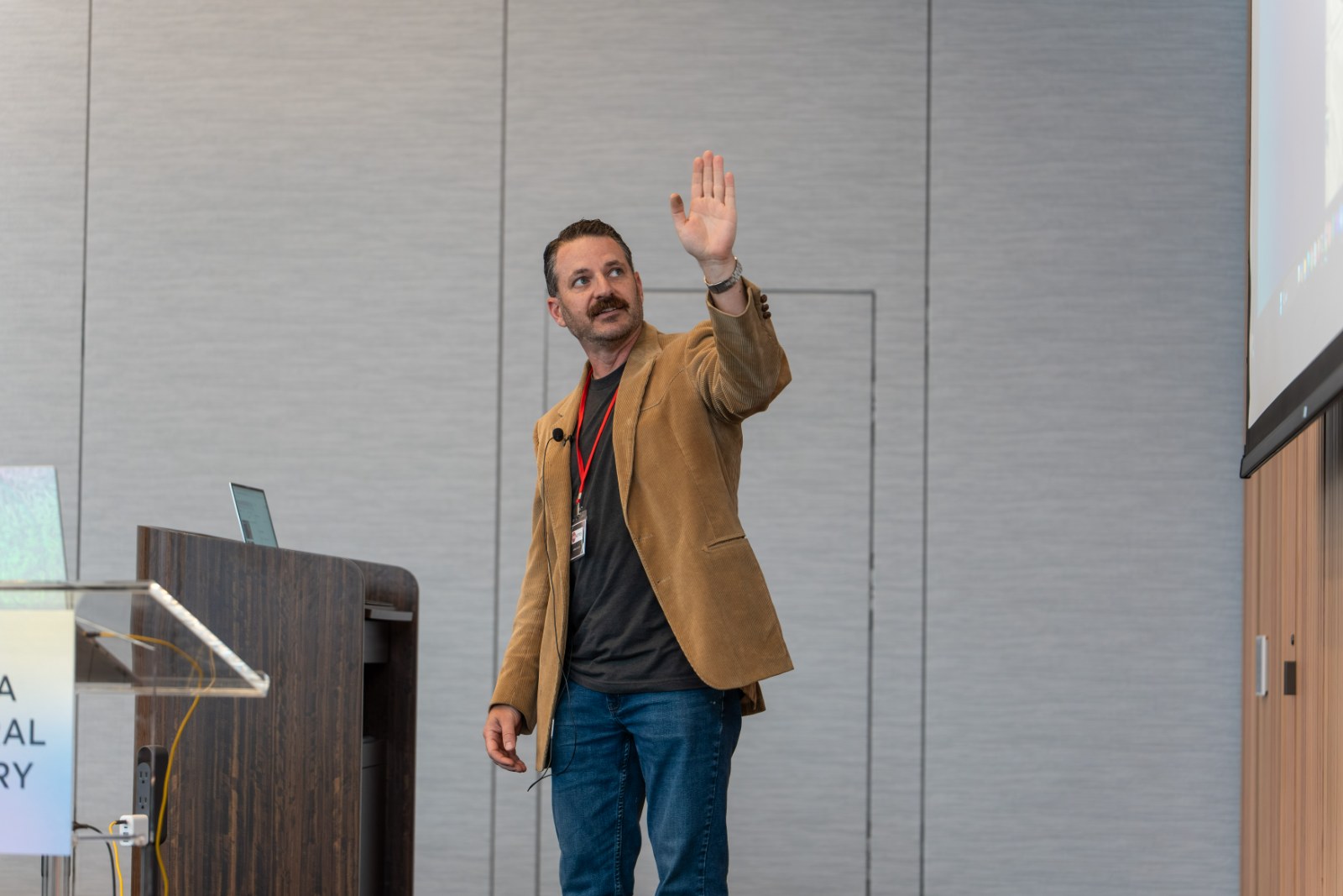 Armen Badeer taking audience questions during a conference talk on AI-assisted software engineering